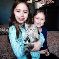 girls with their Siberian cat